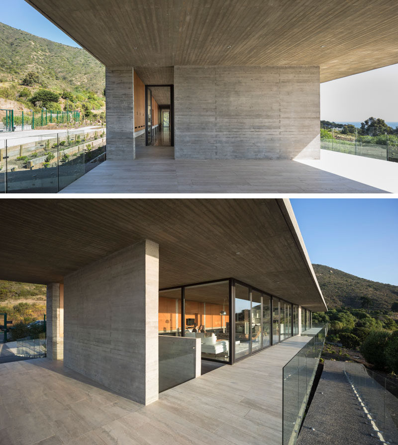 This modern house has a concrete wall with an opening that leads to the glass front door. Click through to see more photos of this concrete house. #ModernHouse #ConcreteHouse