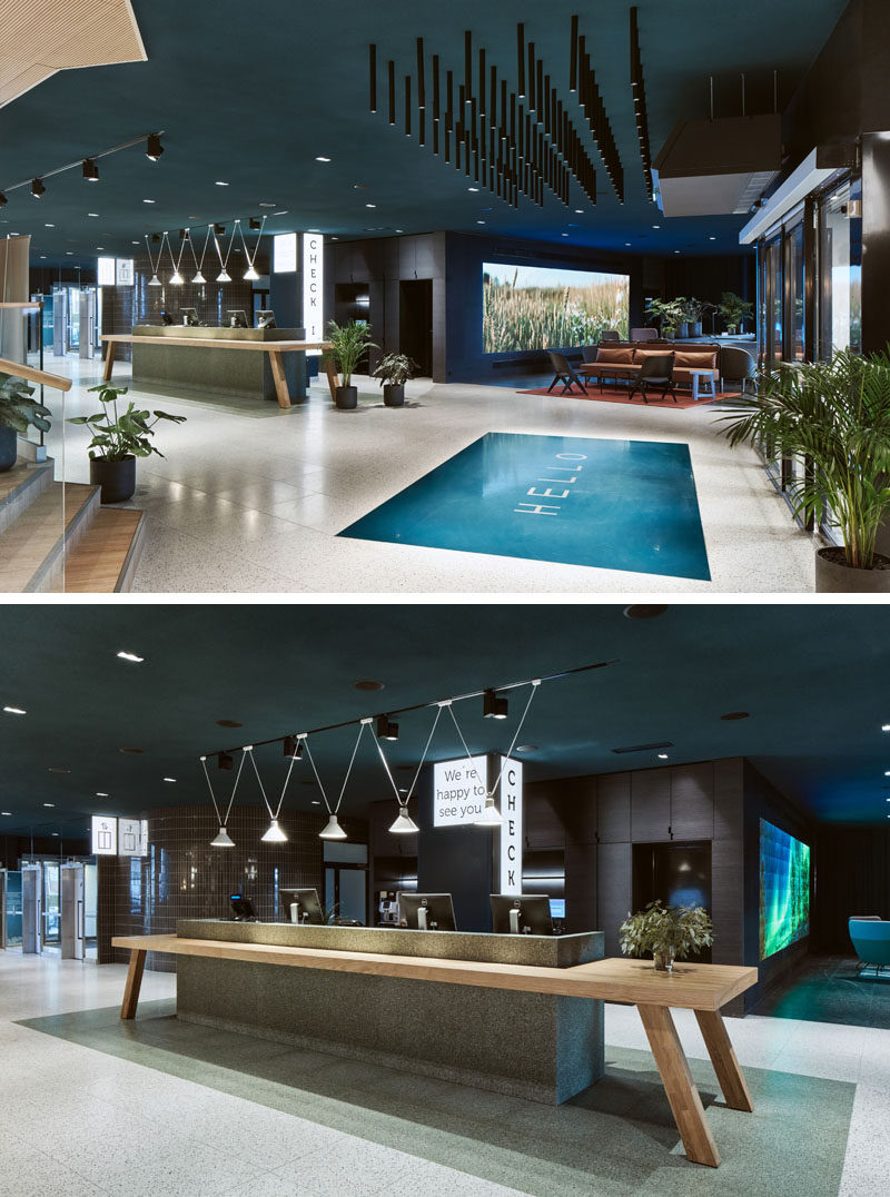 As guests enter this modern hotel in Finland, a large 'HELLO' welcomes them, before reaching the reception desk that resembles a large traditional Finnish wooden dining table. #ModernHotel #HotelReception #Lobby