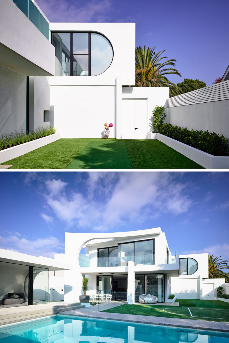 Off to the side of this house is a grassy area with a small cricket pitch and basketball/netball court. Click through to see more photos of this modern house. #Backyard #Landscaping #SwimmingPool #Architecture #ModernHouse