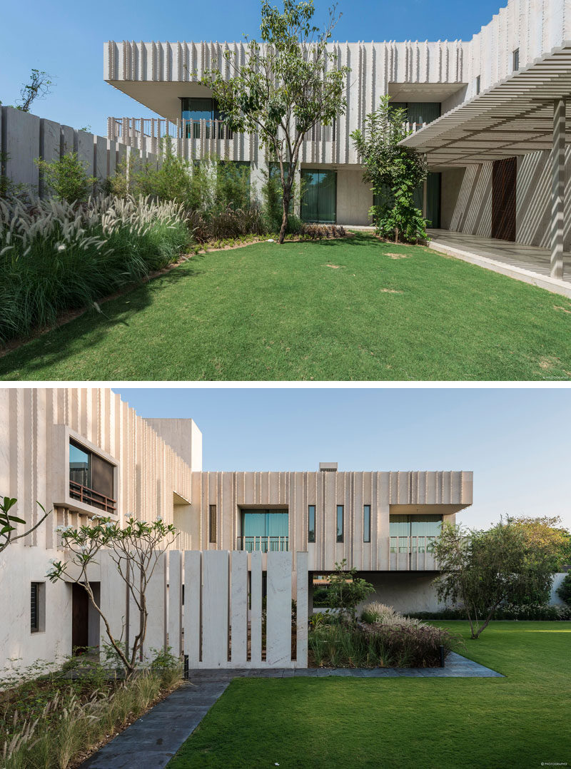 Rough cut stone fins run perpendicular to the facade of this modern house, creating changing shadows throughout the day. #StoneFins #Architecture #ModernHouse