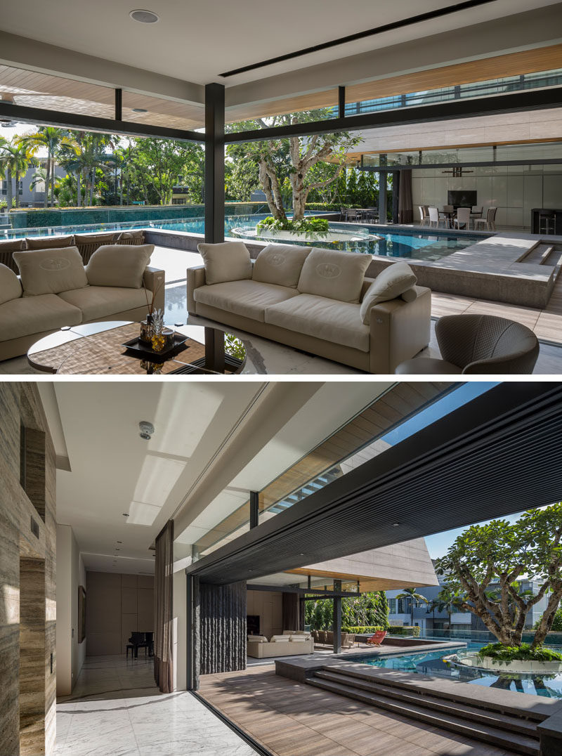 This modern house has retractable walls that open the social areas of the house, like the kitchen, dining and living room, to the wrap around patio and pool. #Kitchen #DiningRoom #SwimmingPool
