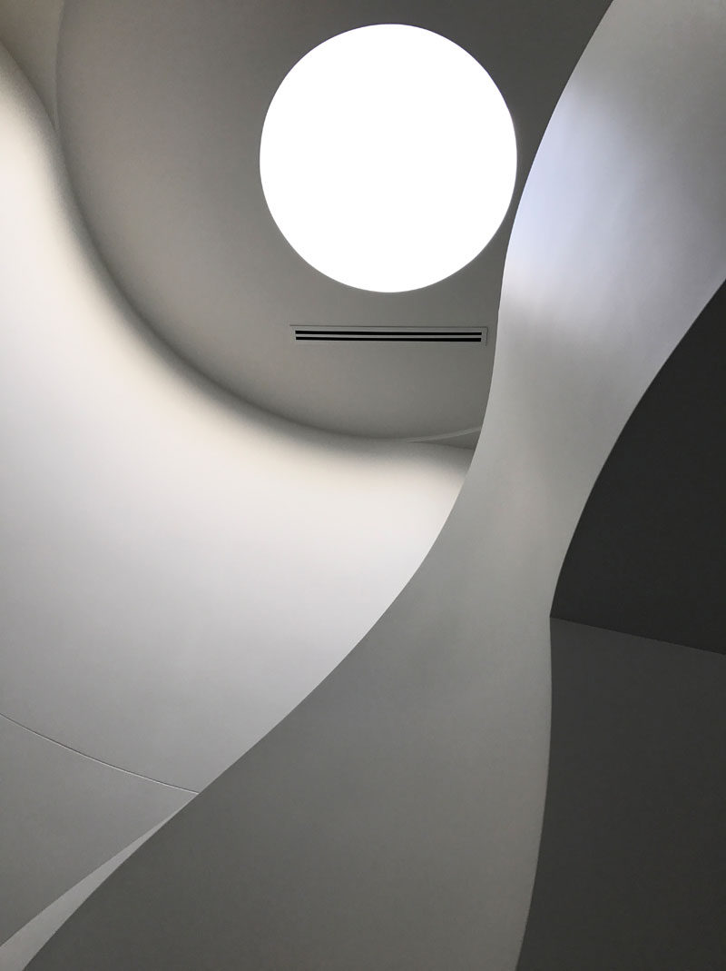 This modern house has a single round skylight that highlights the stairs. Click through to see more photos of this house. #Skylight #Architecture #Windows