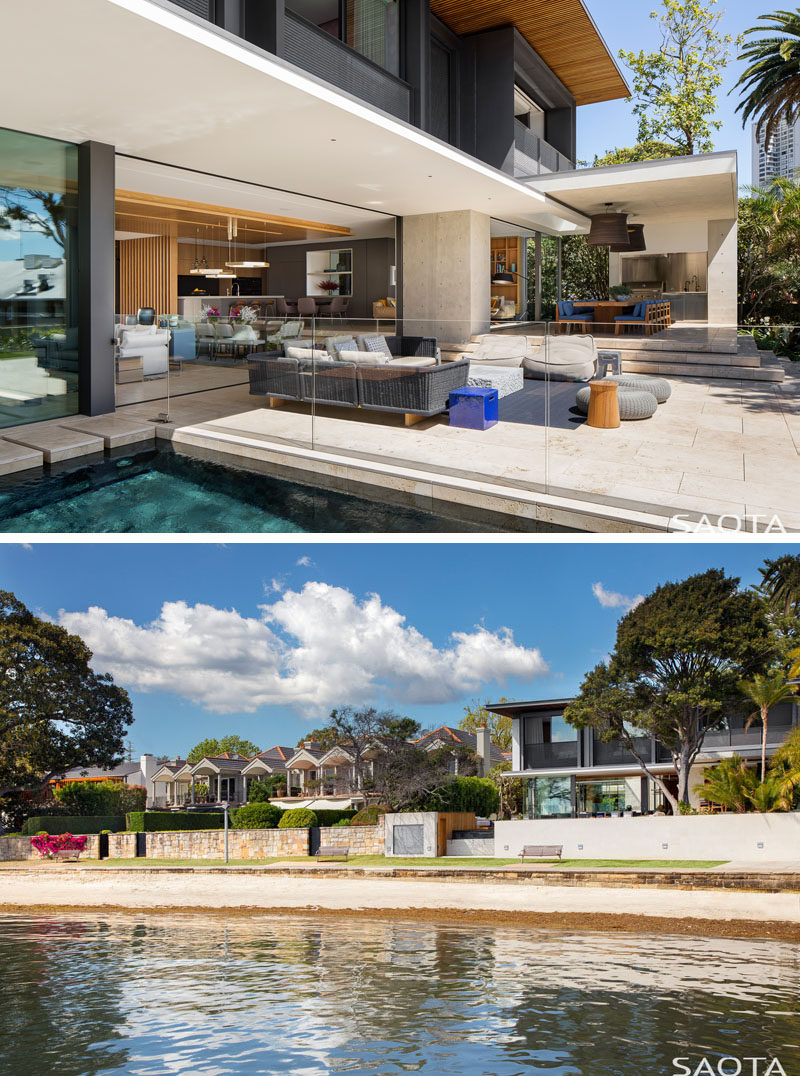 This modern waterfront house has an outdoor terrace with a covered outdoor dining room and bbq area. The use of wood, white walls and travertine floors reflect the seaside setting. #OutdoorDining #Terrace