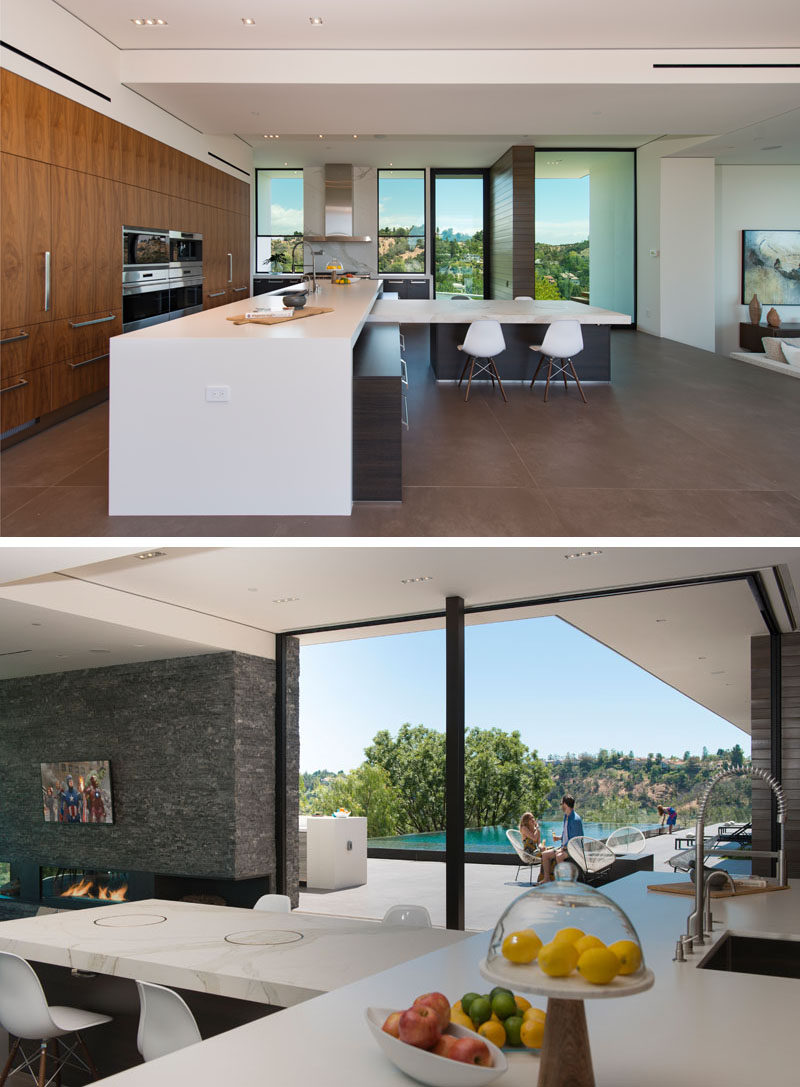 In this modern kitchen, Dekton Quartz has been used for the counters and island, while the cabinets are made from Italian walnut and Wenge wood. The custom kitchen dining table that joins the island is made from Calcutta porcelain, with built-in Yakiniku grills, imported from Japan. #ModernKitchen