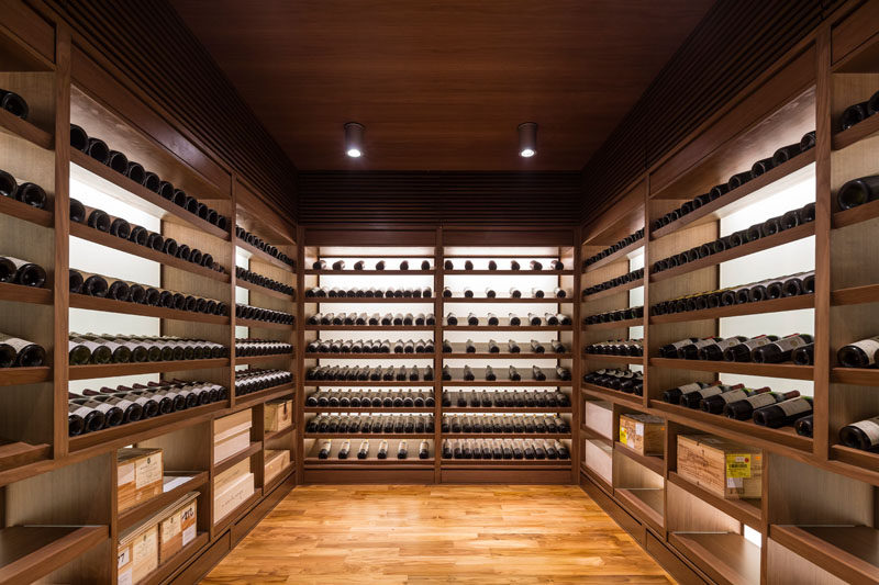 This walk-in wine cellar has plenty of black-lit shelving to nicely display the bottles. #WineCellar #WineStorage #Shelving