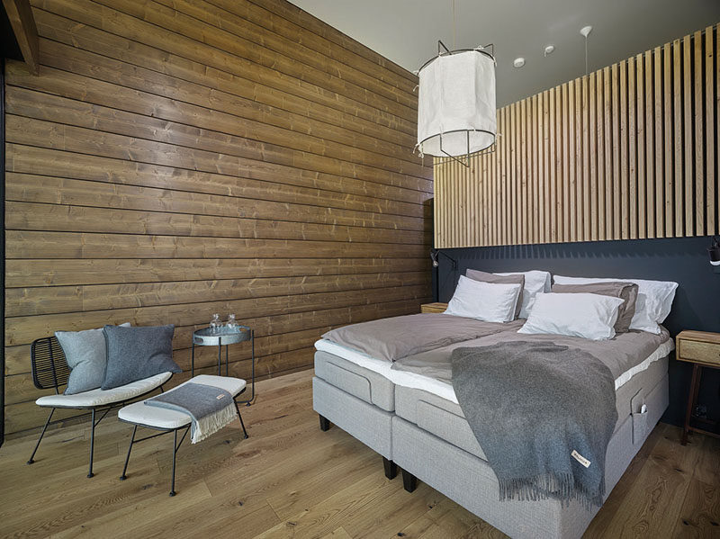 In this master bedroom, wood has been combined with neutral furnishings for a relaxed and contemporary look. #ModernBedroom #WoodWalls