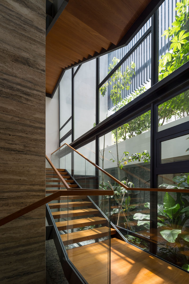 A wood and steel see-through staircase that connects the various levels of this modern house. #Stairs #WoodStairs #Windows