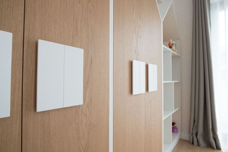 The handles on these house-shaped closet double as 'windows' and help to create a fun space for the child, but as they are larger than normal hardware found on cabinets, it also makes it easier for the child to open their closet. #Closets #Hardware #Cabinets #Handles