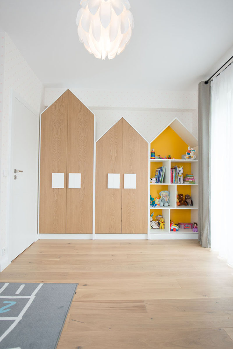 The handles on these house-shaped closet double as 'windows' and help to create a fun space for the child, but as they are larger than normal hardware found on cabinets, it also makes it easier for the child to open their closet. #Closets #Hardware #Cabinets #Handles