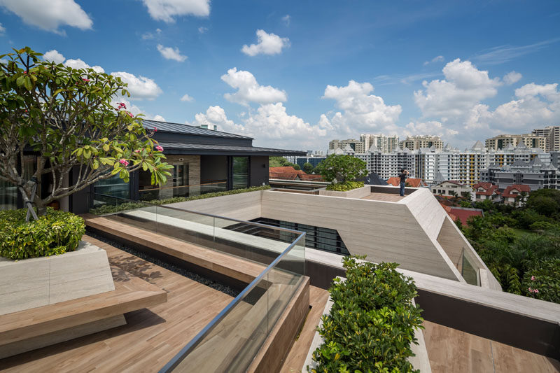 This modern house has an expansive deck with seating and planters, that looks out over the neighborhood. #ModernHouse #Deck #Planters