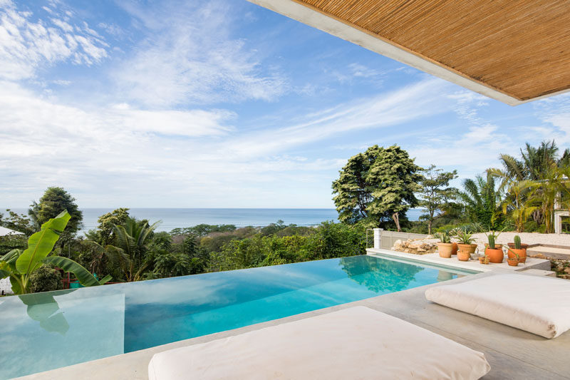 This modern Costa Rican hotel features an infinity pool that provides an unrestricted view of the trees and water in the distance. #InfinityPool #HotelPool #CostaRica