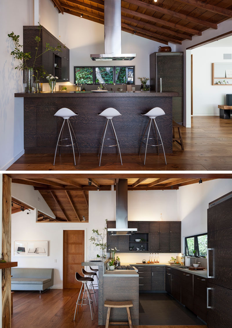 This dark wood kitchen has a stainless steel range vent and hardware to create a contemporary appearance. #DarkWoodKitchen #ContemporaryKitchen #KitchenDesign