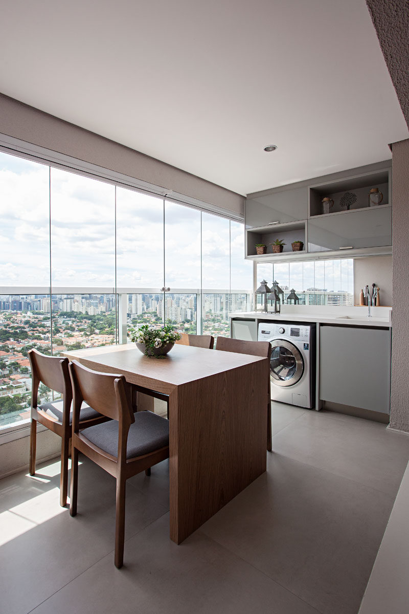 This enclosed balcony has a dining area and built-in laundry that has its own sink. Balcony #Dining #Laundry