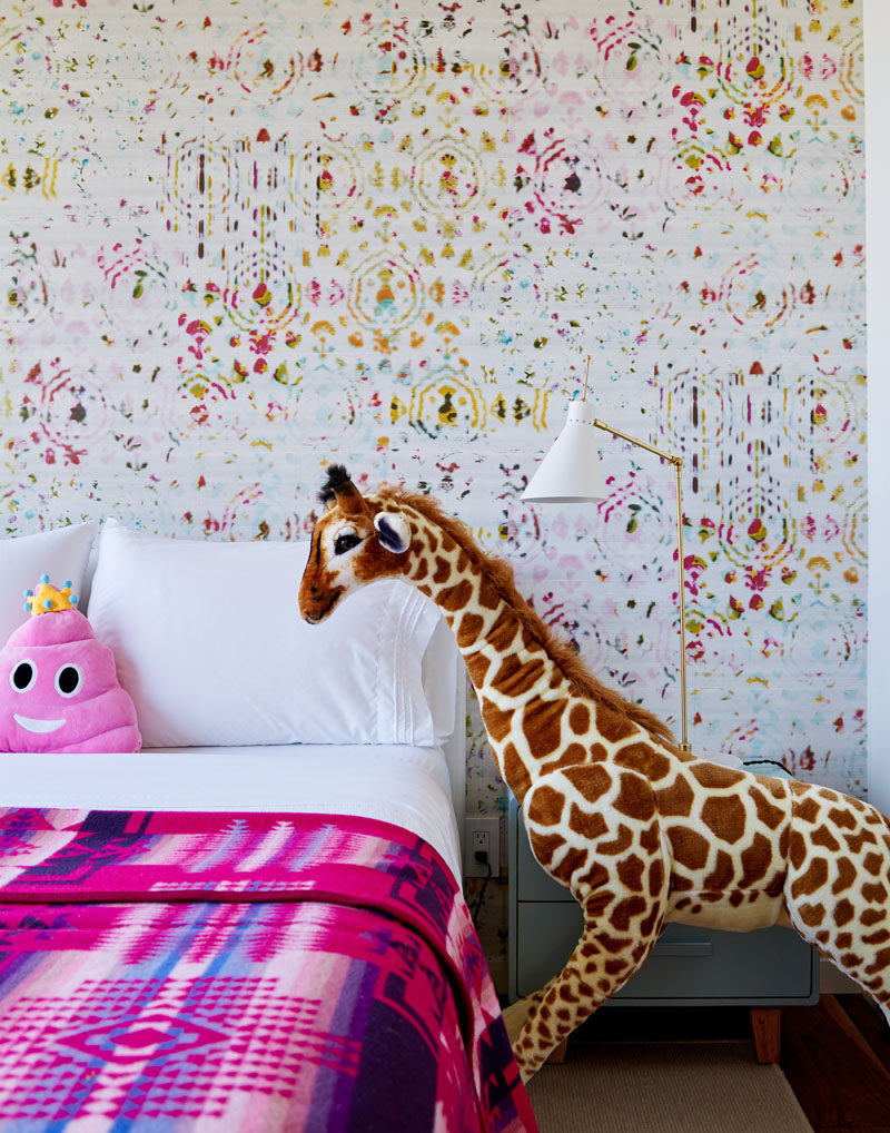 A colorful and patterned wall has been created behind the bed in this kids bedroom. #ModernBedroom #ColorfulBedroom