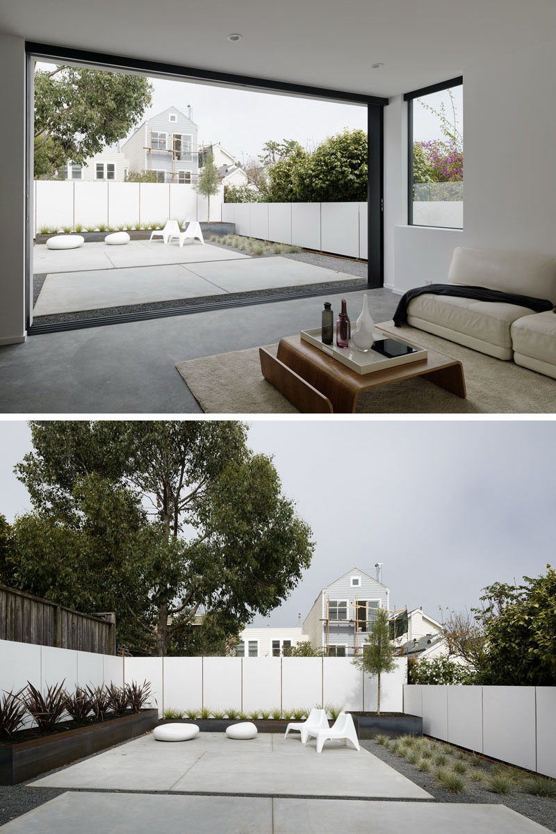 This living room opens up to a simple landscape design helping to keep the backyard maintenance free. #Backyard #Landscaping #Minimalist