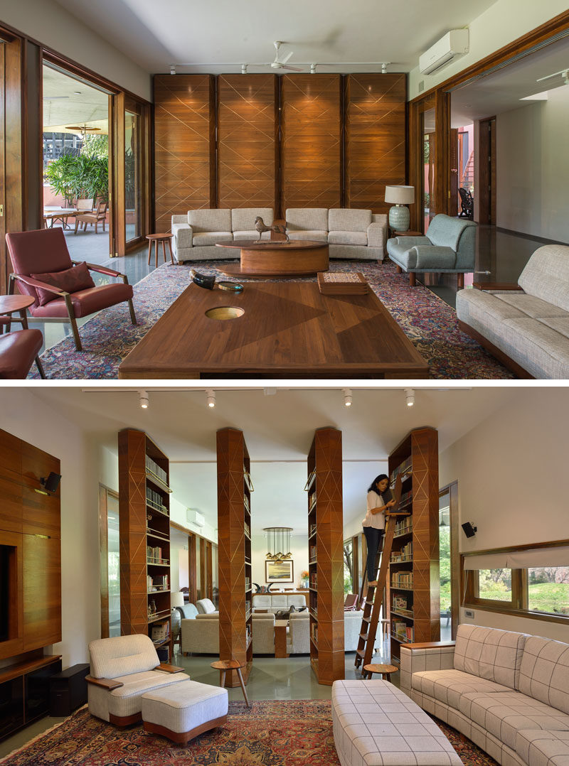 Separating the social areas of this contemporary house are four floor-to-ceiling panels, that when rotated reveal hidden bookshelves and an opening to a secondary living room. #Library #Shelving #Bookshelves #LivingRoom