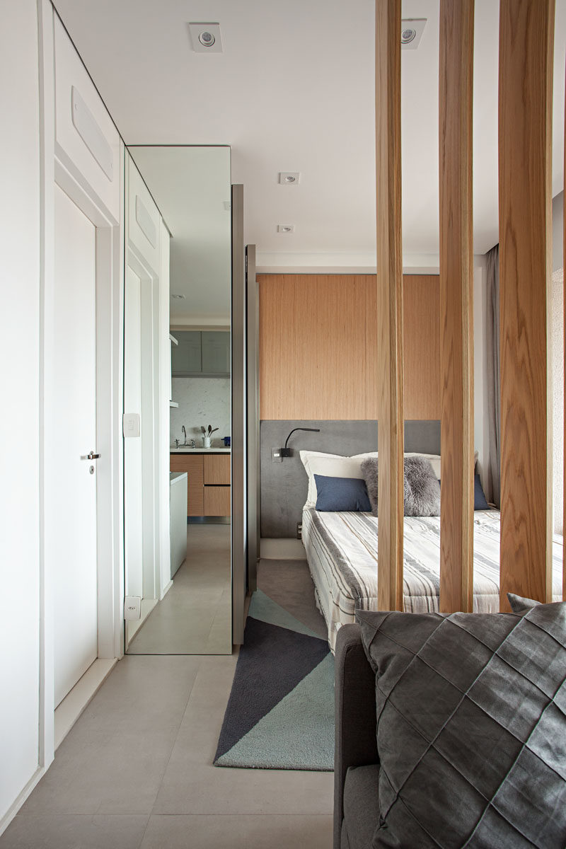 The closet in this bedroom has a floor-to-ceiling mirror on one panel. #BedroomDesign #Closet #Mirror #ModernInterior