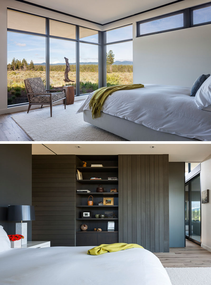 In this modern master bedroom, large windows flood the interior with natural light, while an open shelving unit within a cedar accent wall provides a place for personal items. #MasterBedroom #Windows #Shelving #InteriorDesign