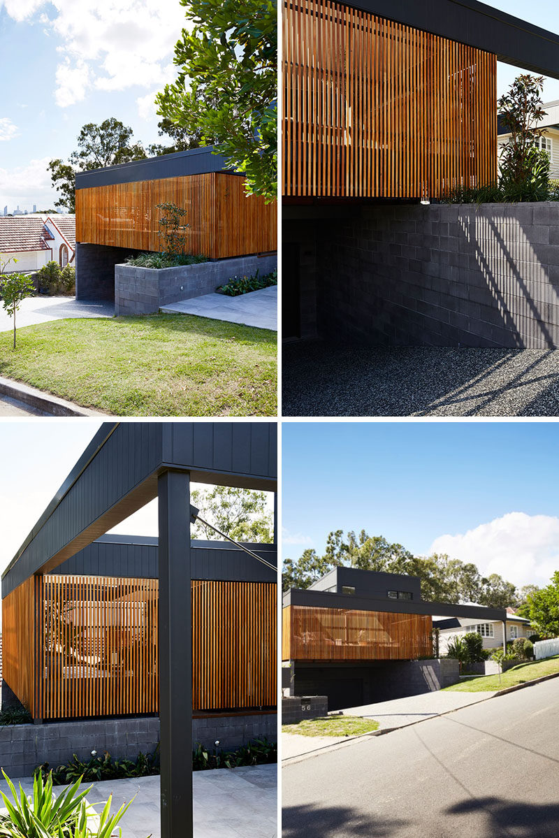 This modern black house has a wood slat detail that hides a private patio. #ModernHouse #ModernArchitecture