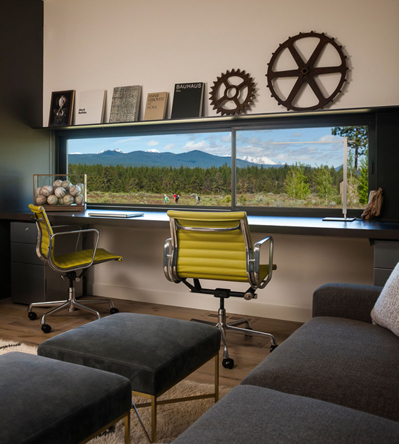 This modern home office has a window that perfectly frames the view. #HomeOffice #Window #InteriorDesign
