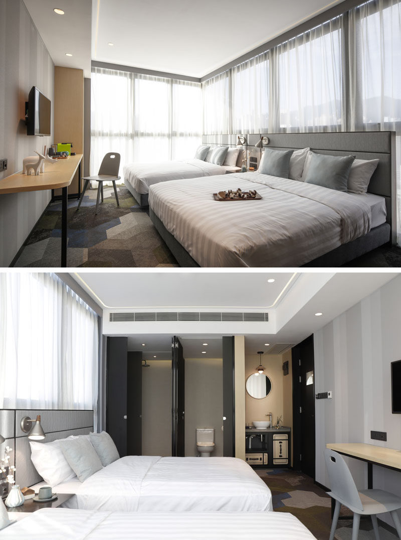 This modern hotel room features sheer white curtains, which is a strong contrast to the black details used in the bathroom and the hotel room door. #HotelRoom #HotelDesign