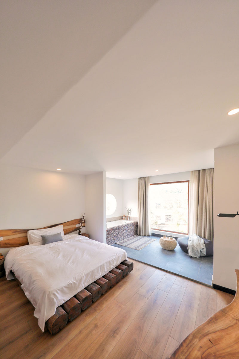 A large window in the bathroom of this modern hotel room, allows natural light to filter through to the sleeping area. #Bedroom #ModernBedroom #ModernHotelRoom #Bathroom