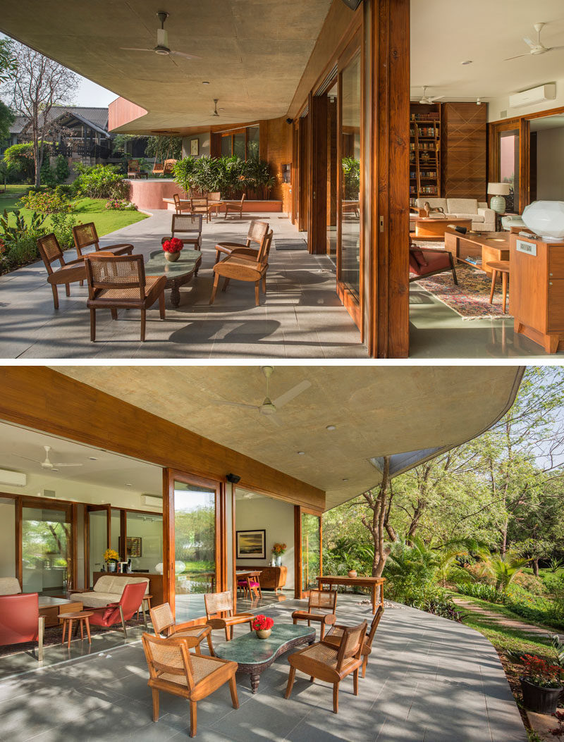 Running along the length of this contemporary house is a covered patio, set up with multiple different areas for relaxing. #Patio #HouseDesign #OutdoorSpaces