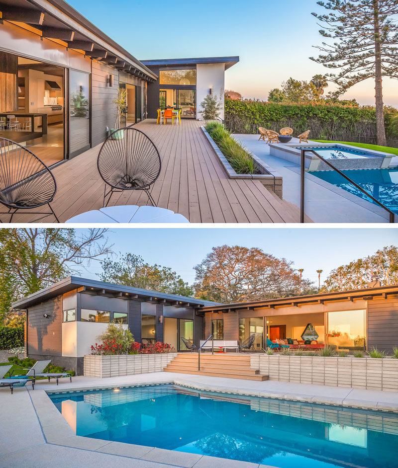 To create a true indoor / outdoor living environment, there's a wrap-around deck on this house that leads to various seating areas, the swimming pool and the backyard. #Deck #Landscaping #SwimmingPool