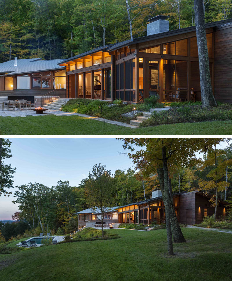 This modern house in the woods has a patio area with a firepit, before stairs lead down to the swimming pool. #ModernHouse #Landscaping #FirePit #Patio