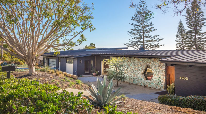 This renovated mid-century home in California has a turquoise stone accent wall and a custom designed window. #Architecture #Stone #Window