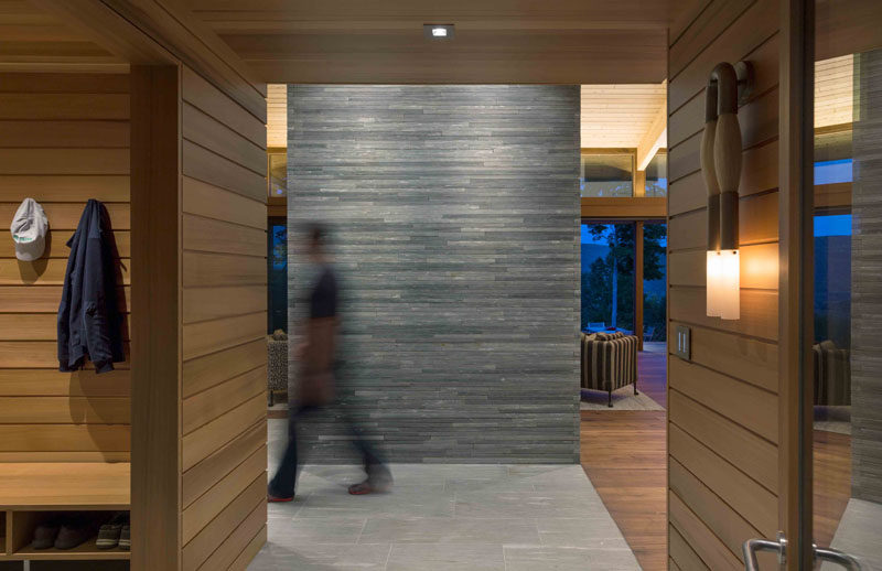 The interiors of this modern house are clad with western red cedar walls, with walnut and natural stone floors. #InteriorDesign #InteriorMaterials #StackedStone #WalnutFlooring #StoneFlooring #CedarWalls #RedCedar