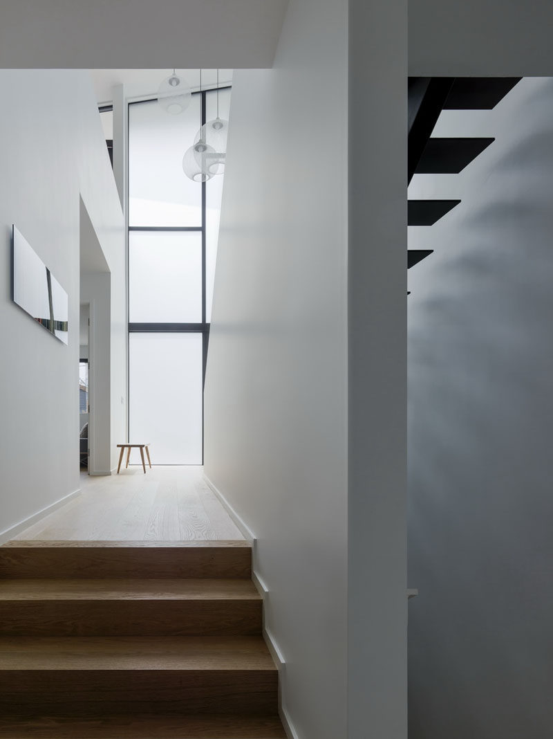 This modern house has both wood stairs and black painted steel stairs. #ModernHouse #FrostedWindows #WoodStairs #BlackStairs