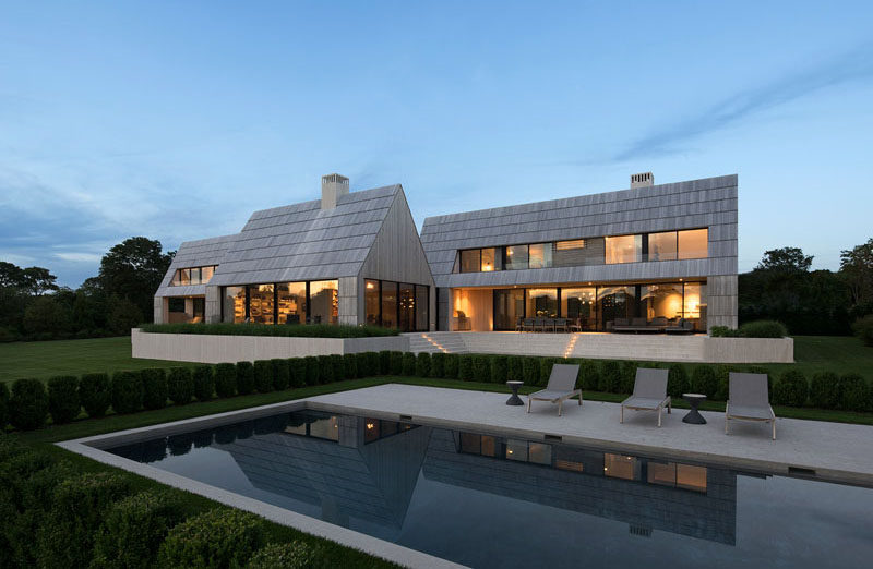 This modern house has cedar shingles have been scaled up to the size of boards to cover the roof and sidewalls, while cedar screens provide privacy and filter light. #Shingles #Architecture #ModernHouse