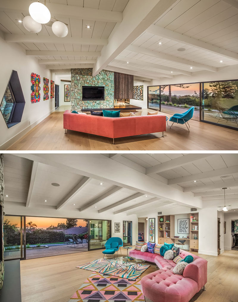 Stepping inside this renovated mid-century modern house, the living room is large and open, with steel and glass partition walls and windows that open it to the deck. #LivingRoom #StoneFireplace #TurquoiseStone #ModernInterior