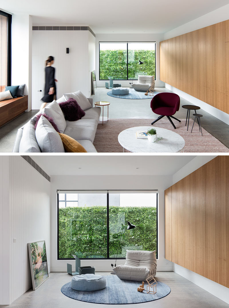 This modern living room features a small quiet reading area that has large windows to fill the area with natural light. #LivingRoom #ModernLivingRoom #Windows