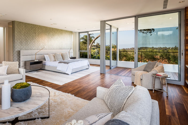 This modern and large master suite is positioned for maximum views and privacy, and it includes a private terrace and a fireplace. #MasterSuite #BedroomDesign #InteriorDesign