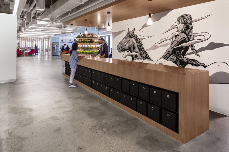 In this modern healthcare office , the company's icon, Joan of Arc, has been added as a large contemporary mural that spans the width of a wall. #Mural #Art #OfficeDesign #Workplace #InteriorDesign