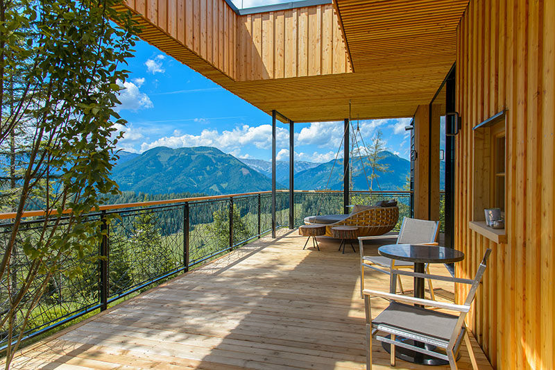 This modern chalet in Austria features a large balcony that looks out towards the mountains. #Balcony #Chalet