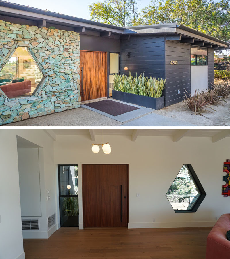 At the front of this renovated mid-century modern house is an oversized mahogany pivoting front door and a one-of-a-kind steel framed custom hexagon window. #PivotingFrontDoor #OversizedDoor #StoneWall #CustomWindow #Window