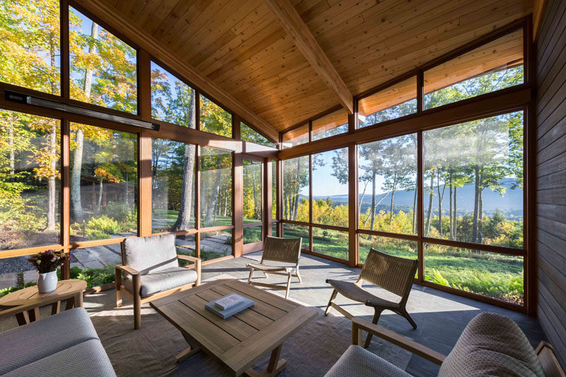 This modern house has a large screened in porch with views of the trees. #Porch #EnclosedPorch #Sunroom