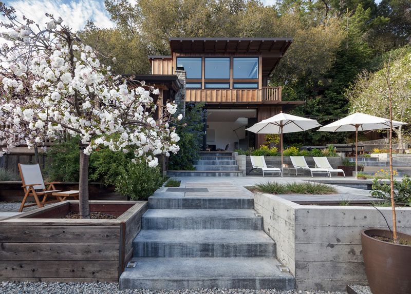 A two-storey addition with board and batten wood siding was added to a small cottage in California. #ModernAddition #Architecture #Cottage #Landscaping