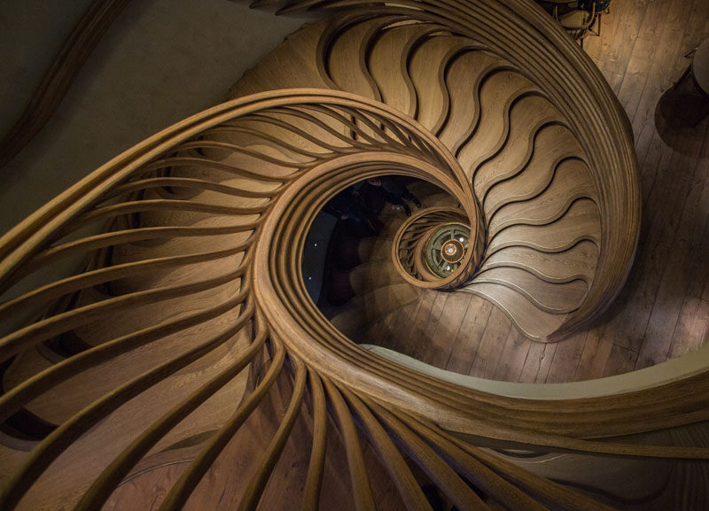 Atmos Studio have designed a sculptural wood spiral staircase that's the centerpiece for the 3-storey HIDE restaurant in London. Click through to see more photos of the staircase. #SpiralStairs #SculpturalStairs #Architecture #Design #WoodStairs