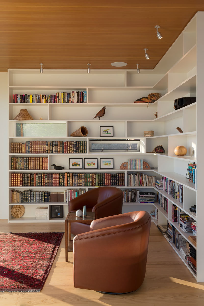 This reading nook is formed by walls of bookcases, which flow seamlessly out of the smaller scattered window pattern. #Bookshelves #Shelving