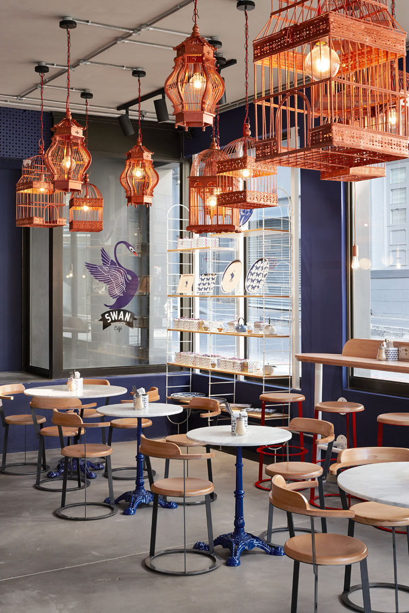 Haldane Martin have recently completed a new café for Cape Town: a traditional French crêperie called Swan Café. #CafeInterior #InteriorDesign #CopperLighting #BirdcageLighting