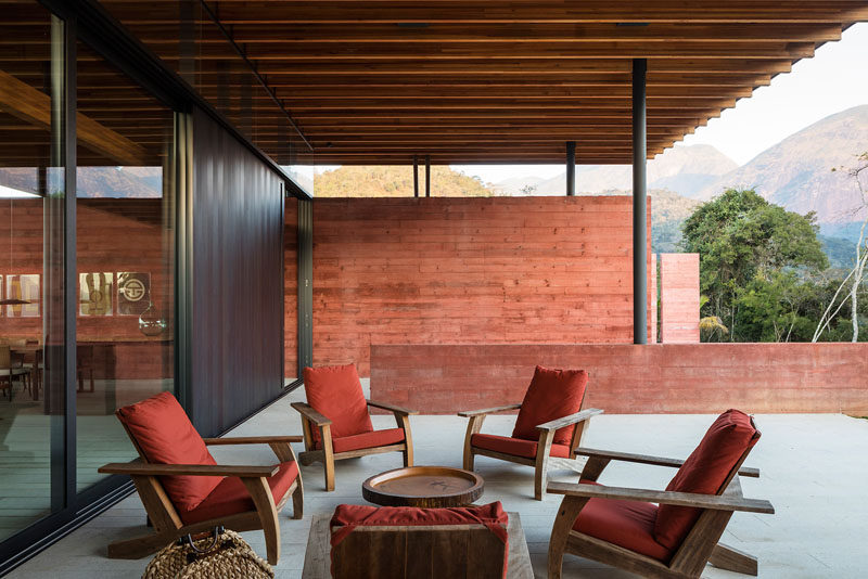 This modern house has pigmented concrete walls that create a colorful backdrop throughout the house. #ConcreteWalls #PigmentedConcrete #OutdoorSpace #Patio