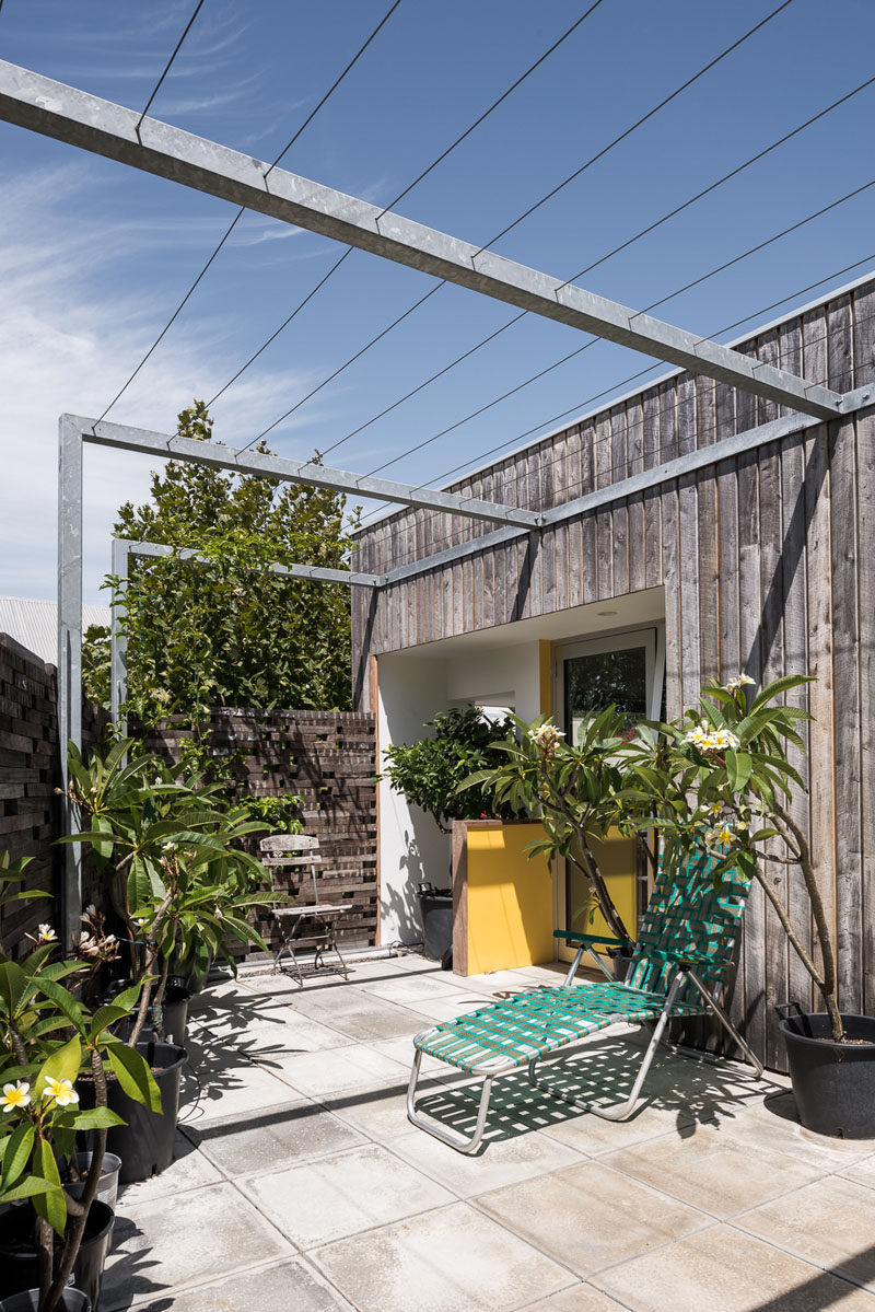 This private patio is surrounded by wood, and an overhead trellis will allow plants to create a shade cover over the outdoor space over time. #Patio #OutdoorSpace