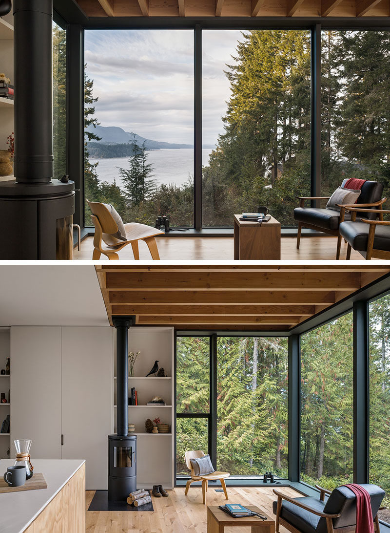This modern cabin has lightly painted panels and soft pine plywood to help warm and brighten the interior, while the floor-to-ceiling windows provide sweeping views of the trees and water. #ModernCabin #Windows #FullHeightWindows