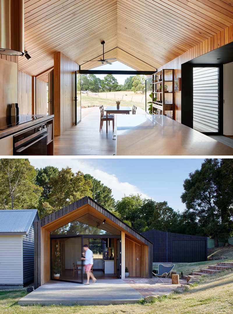 This modern house addition has two large steel doors that frame the landscape in winter, and open up to extend the living area in summer.  #ModernAddition #Gabled #WoodCeiling #ModernArchitecture #Doors