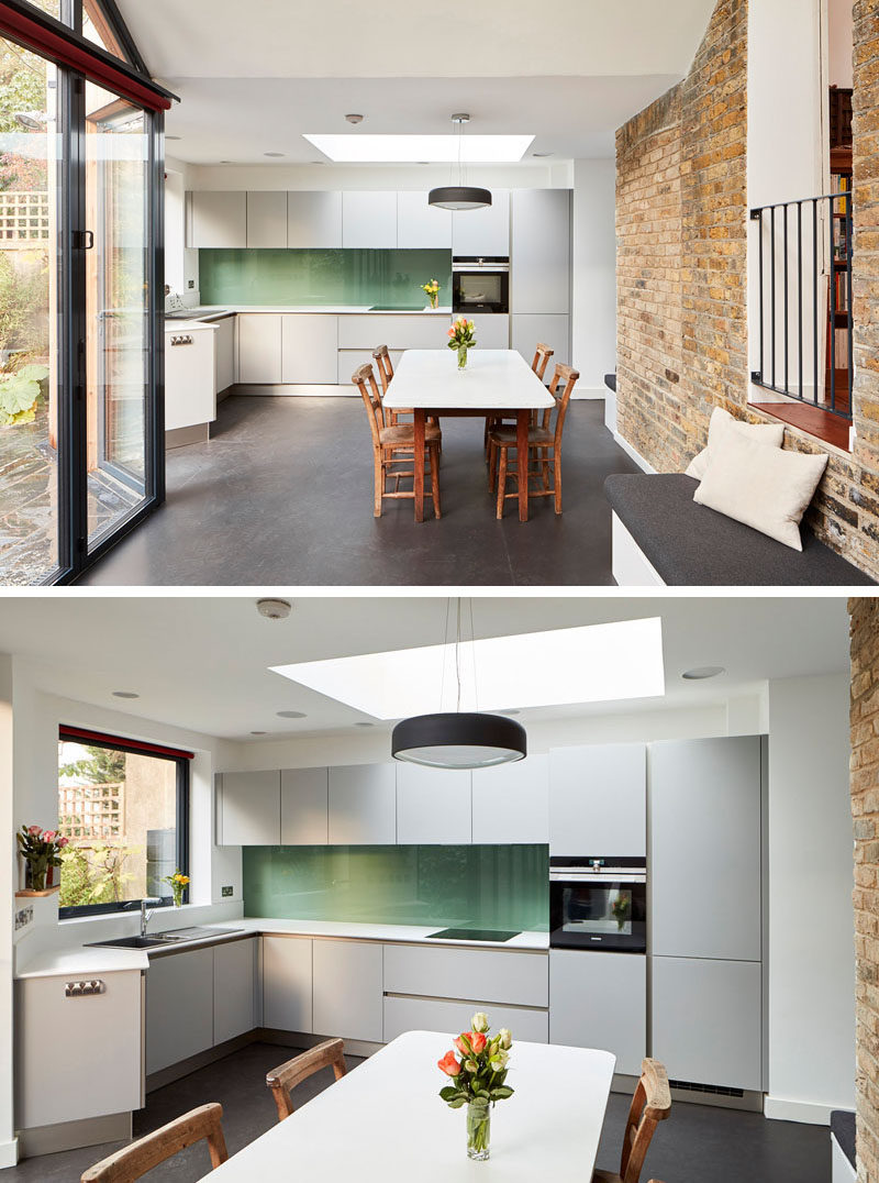 This old house has a new extension with a kitchen that features light grey cabinets, white countertops and a green backsplash. #KitchenDesign #SimpleKitchen #GreyCabinets