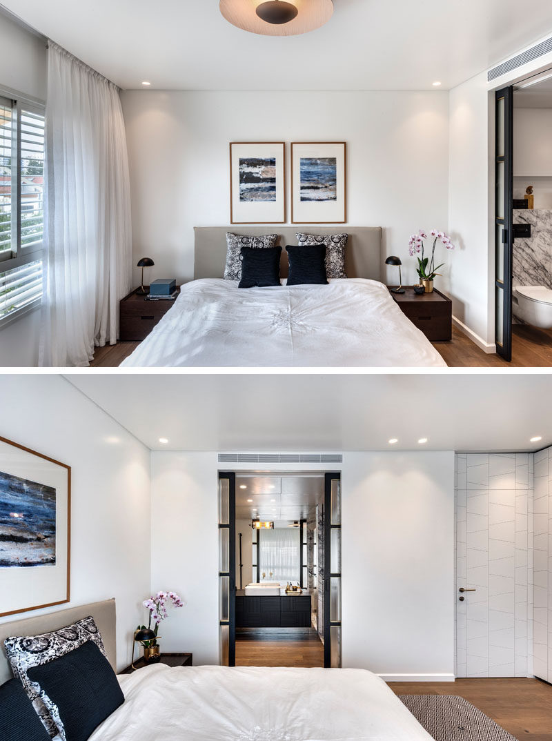 This modern master bedroom has an ensuite bathroom that can be accessed via a set of black framed sliding glass doors. #MasterBedroom #BedroomDesign